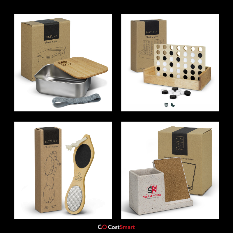 A four-panel collage showcasing eco-friendly branded lifestyle products from the Natura range, including a stainless steel lunch box with a bamboo lid, a wooden "Connect Four" style game, a bamboo pedicure tool, and a speckled desk caddy with a cork note board. It is advertised by CostSmart.